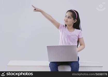 Little girl with a laptop pointing