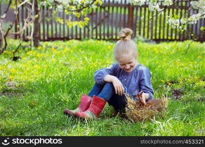 little girl with a rabbit in the garden, spring