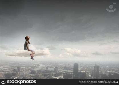 Little girl with bear. Cute girl wearing pajamas with toy bear in hand sitting on cloud