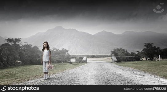 Little girl with bear. Cute girl wearing pajamas with toy bear in hand