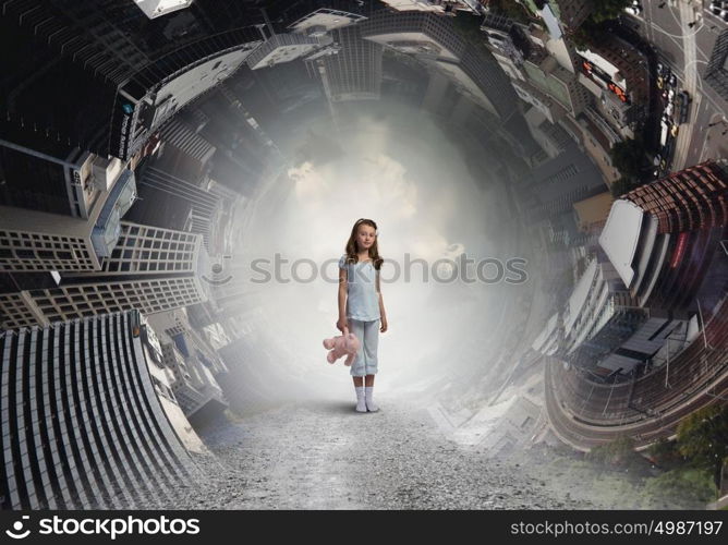 Little girl with bear. Cute girl wearing pajamas with toy bear in hand