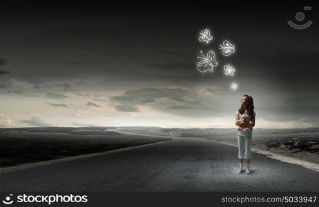 Little girl with bear. Cute girl wearing pajamas with toy bear in hand