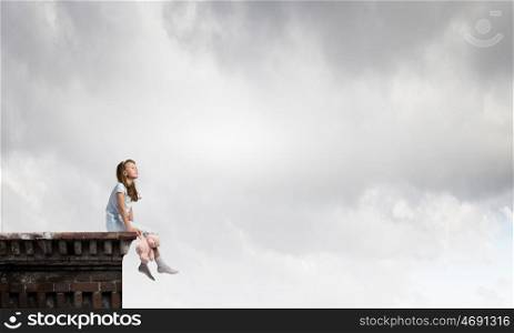 Little girl with bear. Cute girl wearing pajamas with toy bear in hand on top