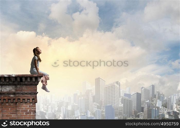 Little girl with bear. Cute girl wearing pajamas with toy bear in hand on top