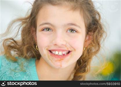 Little girl with chocolate around her mouth