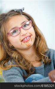 Little girl with chocolate around her mouth