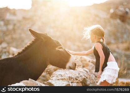 Little girl with donkey on the greek island. Little girl with donkey on the island of Mykonos