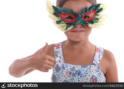 Little girl with feather mask