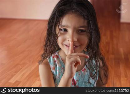 Little girl with finger on lips