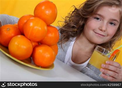 Little girl with glass of orange juice