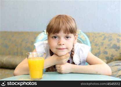 little girl with glass of orange juice