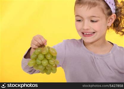 Little girl with grapes