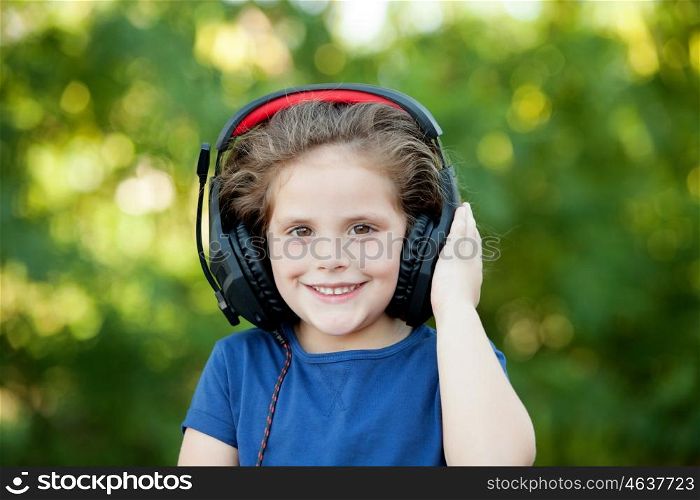 Little girl with headphones on a park