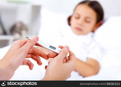 Little girl with illness at bed at home