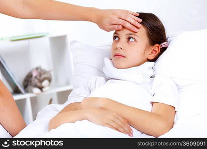 Little girl with illness at bed at home