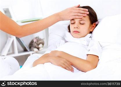 Little girl with illness at bed at home