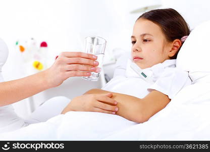 Little girl with illness at bed at home