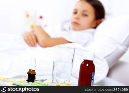 Little girl with illness at bed at home