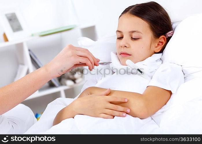 Little girl with illness at bed at home