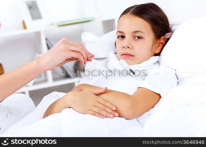 Little girl with illness at bed at home