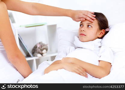 Little girl with illness at bed at home