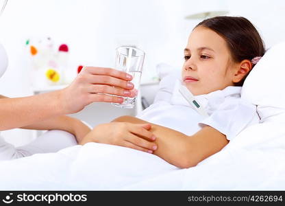 Little girl with illness at bed at home