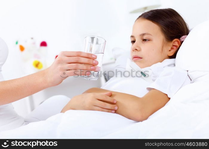 Little girl with illness at bed at home