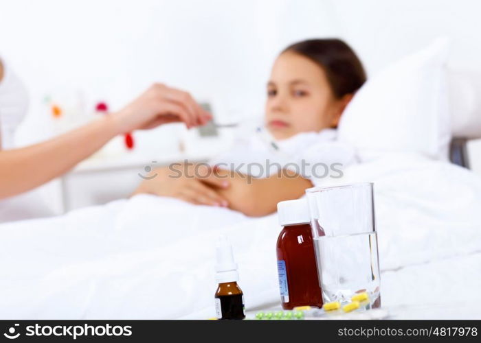 Little girl with illness at bed at home