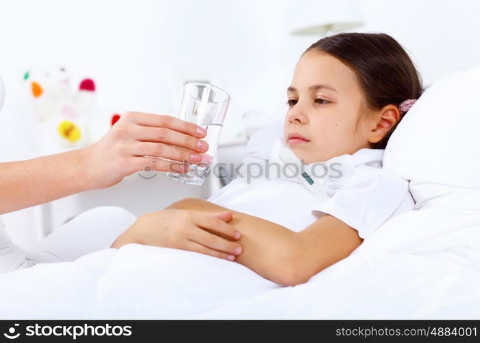 Little girl with illness at bed at home