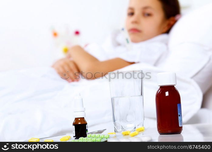 Little girl with illness at bed at home