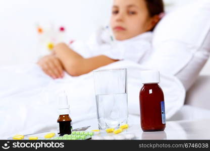 Little girl with illness at bed at home