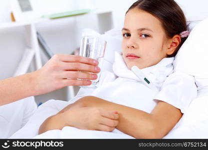 Little girl with illness at bed at home