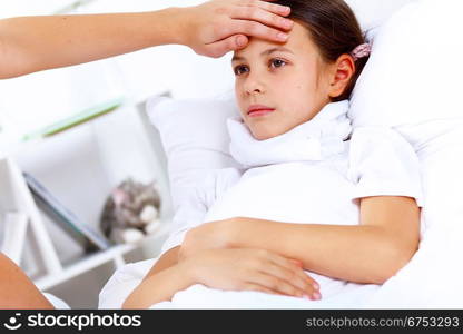 Little girl with illness at bed at home