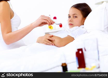 Little girl with illness at bed at home