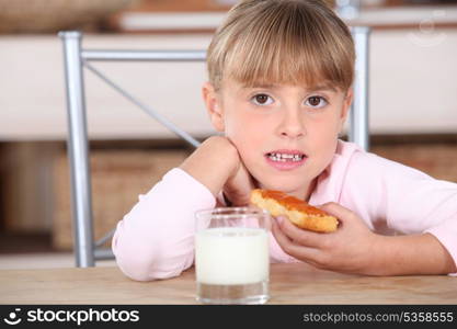 Little girl with jam and milk