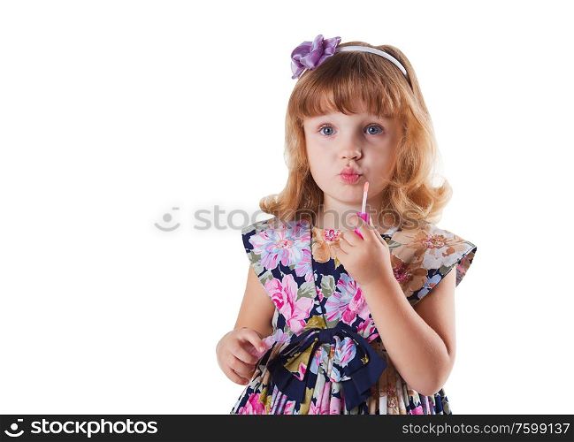 little girl with lipstick in hand in dress with flowers on white background