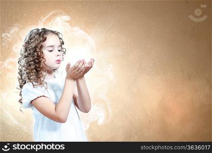 Little girl with magic lights and shining around