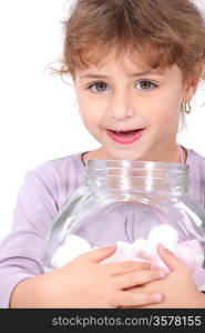 Little girl with marshmallows on white background