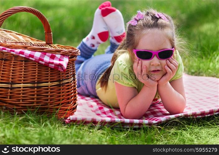 Little girl with picnic basket at forest
