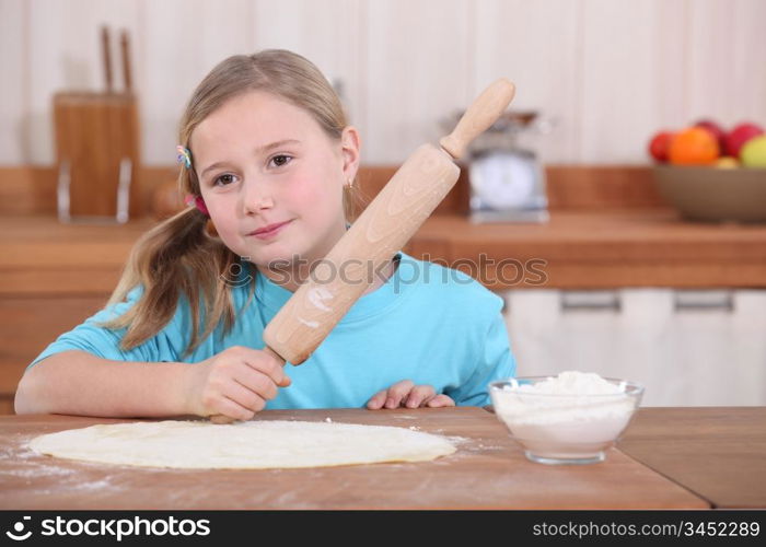 Little girl with rolling pin