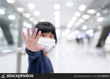 Little girl with surgical mask face protection flu and Virus outbreak in public transportation (skytrain or subway). Concept of New normal lifestyle, Using public transport to travel to school.