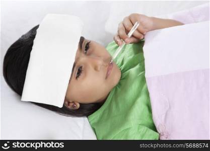 Little girl with thermometer in mouth