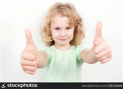 Little girl with thumbs up on white background
