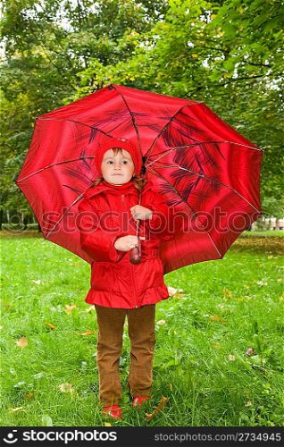 little girl with umbrella in park