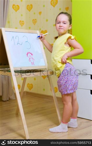 Little girl with whiteboard at home