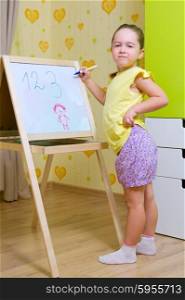 Little girl with whiteboard at home