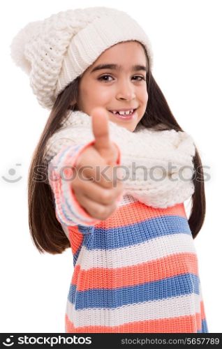 Little girl with winter clothes doing thumbs up