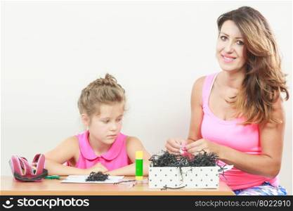 Little girl work with mom. Parenting, cooperation, common fun