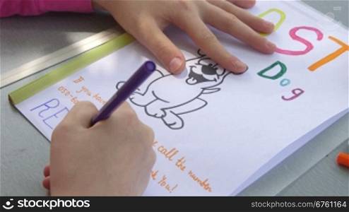 Little girl writes missing pet poster offering a reward