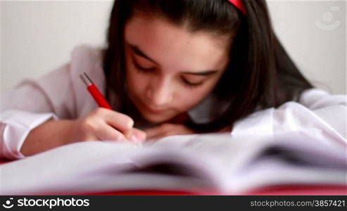 Little girl writing at home